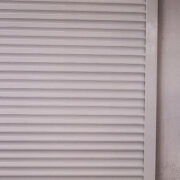 White Steel Roller Shutter Door, suitable for use as industrial background.